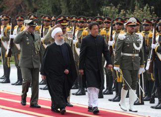 Iranian President Hassan Rouhani walks with Pakistani Prime Minister Imran Khan during a welcome ceremony in Tehran, Iran, April 22, 2019. (Reuters)